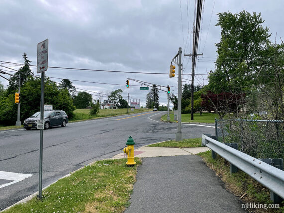 Street intersection with a small trail end sign.