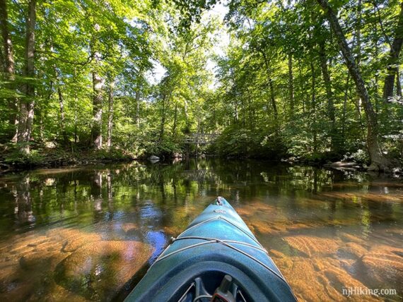 Kayak on a shallow river with rocks visible in the water