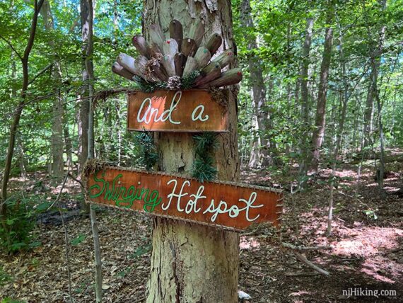 And a swinging hot spot wooden sign on a tree.