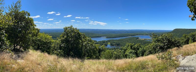 Panoramic view over New Jersey with a reservoir in the valley and a prominent cliff above it.