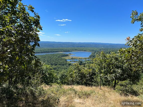 Bright blue reservoir seen from a ridge viewpoint along the Appalachian Trail.