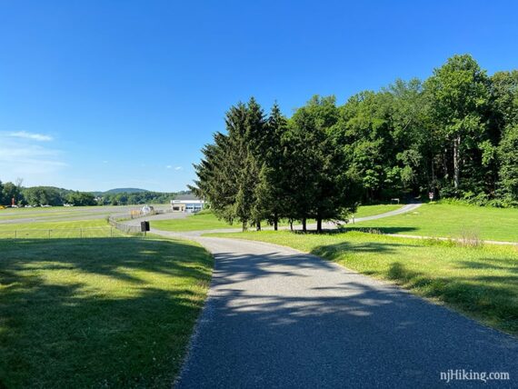 Wide park road with a small airport in the distance