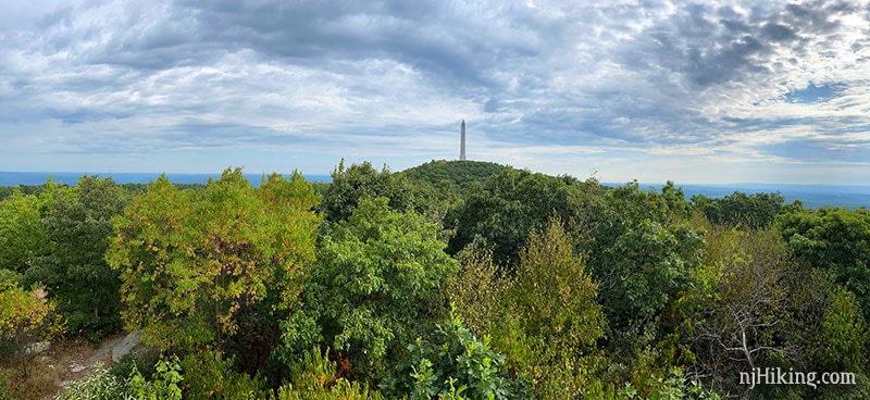 Panoramic view of the High Point Monument with an expanse of green trees in the foreground.