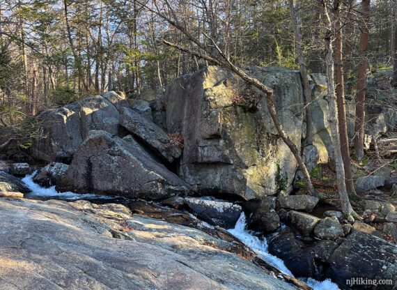 Large bouldercalled Gus-Nah-Quah Rock near a stream. 