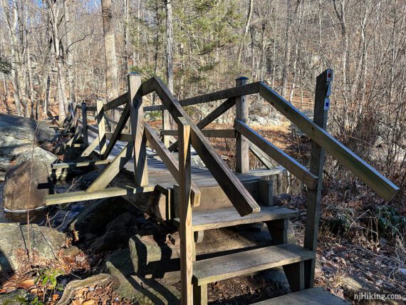 Wooden trail bridge over Pine Meadow Brook.