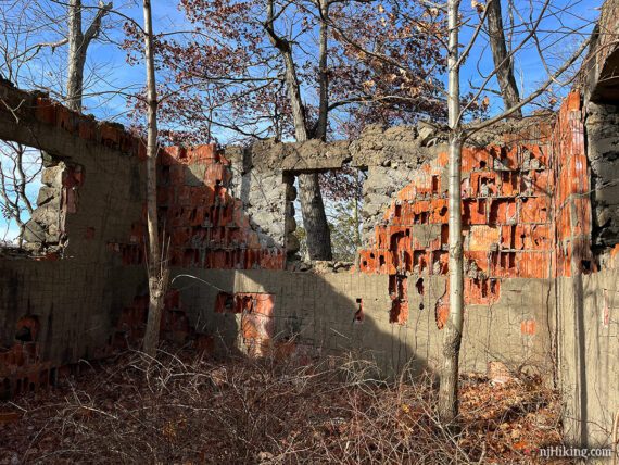 Crumbling interior walls of a ruined pumphouse.