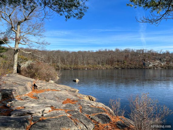 Flat rocky outcrop next to a lake.