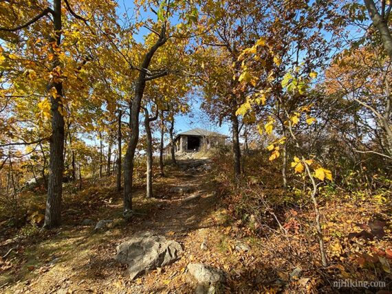 Trail approaching a large stone pavlion.