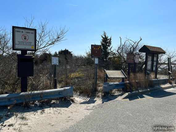 Multiple signs at Corson's Inlet trailhead.