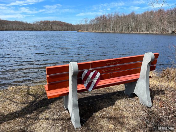 Orange bench and a wooden heart with love written on it.