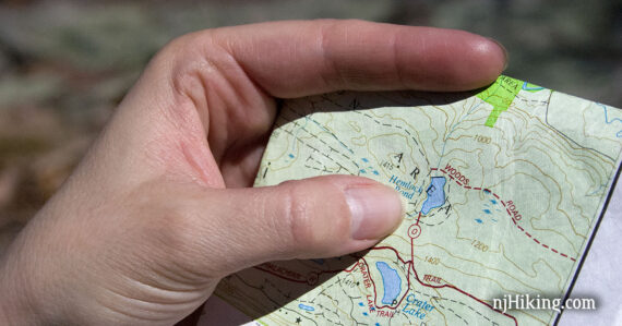 Hand holding a trail map.