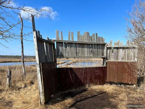 Large wildlife blind with uncut wood on the top edge.