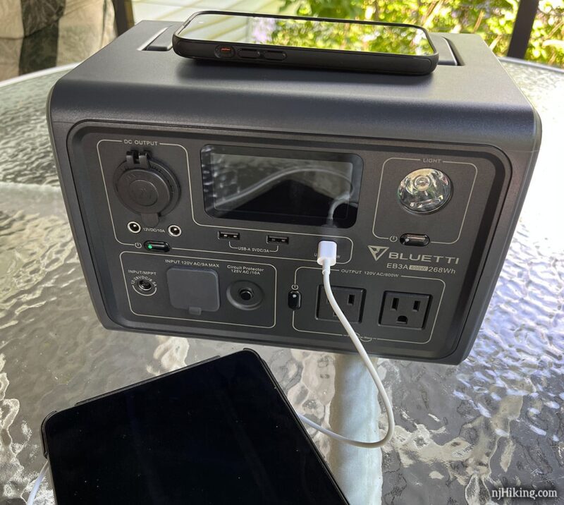 iPad being charged by a portable power station.