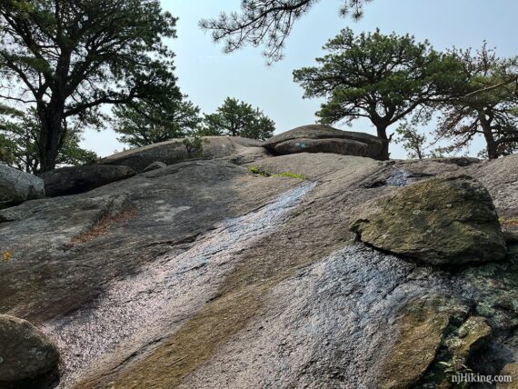 Large slanted rock slab approaching a viewpoint.