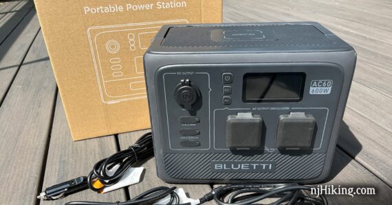 Bluetti AC60 portable power station with cords and box.