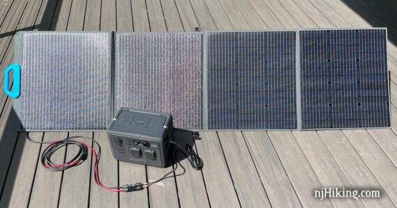 Solar panel angled towards the sun and plugged into a portable power station.