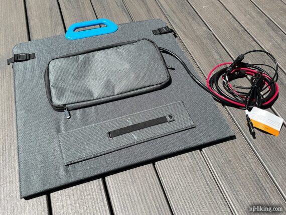 Back of folded solar panel with a zippered pocket for the cable.