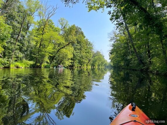 Canoe paddling ahead on a canal.