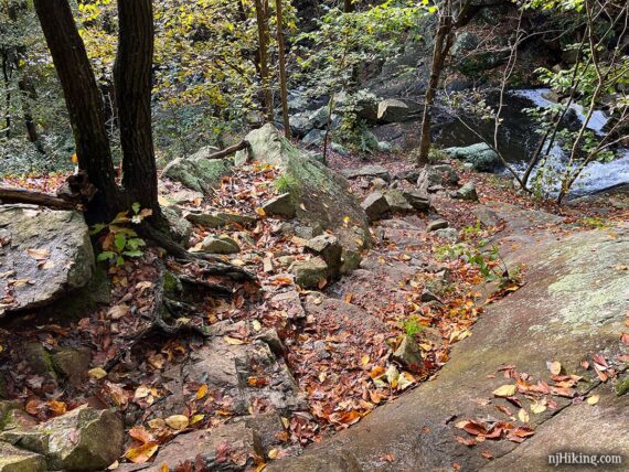 Rock steps leading downhill to a waterfall.