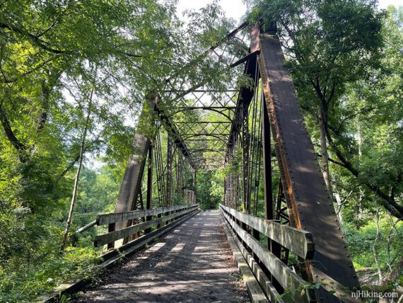 Large bridge with metal work overhead.