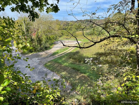 View from a rail-trail above a road intersection and parking area.