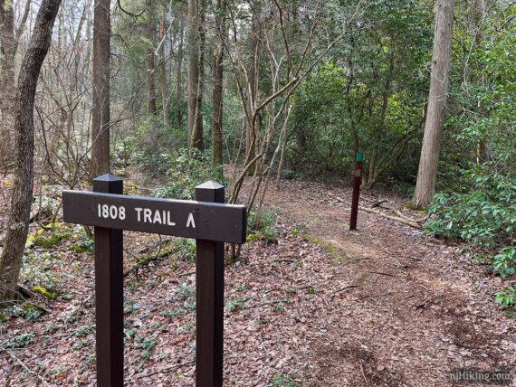 1808 Trail sign along a path.