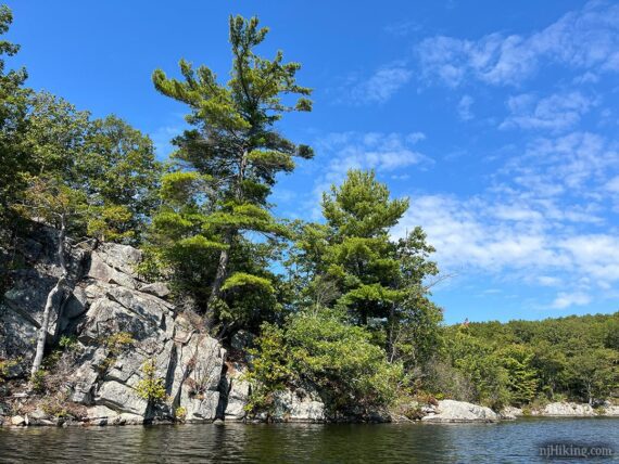 Tall rocky shoreline of lake.