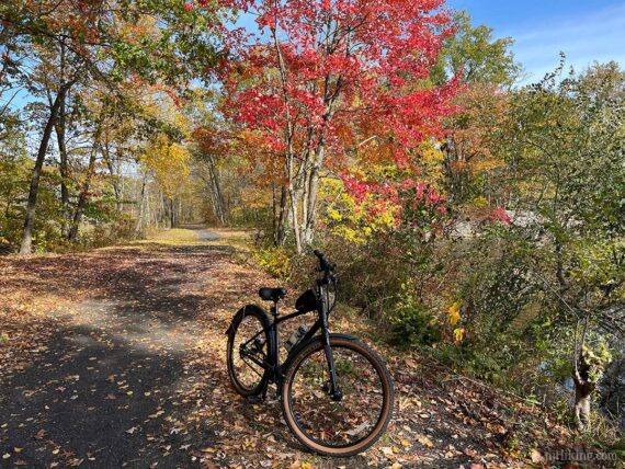 Bike on the Sussex Trail with bright red foliage.