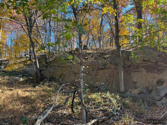 Long tall rock wall.