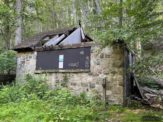 Old restroom building with caved in roof.