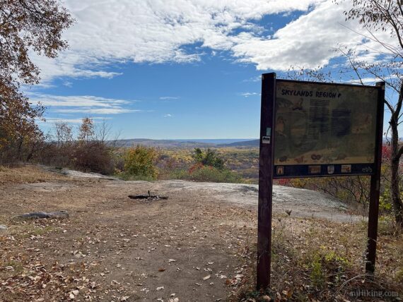 Open ledge of the hawk watch with a sign to one side.
