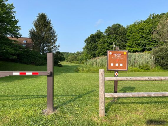 Pump house trailhead sign and fence.